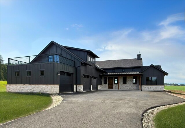 168 Wood Ridge Dr, Columbia Falls, MT 59912 - kitchen with stainless steel appliances, a towering ceiling, wall chimney range hood, a kitchen island, and light wood-type flooring