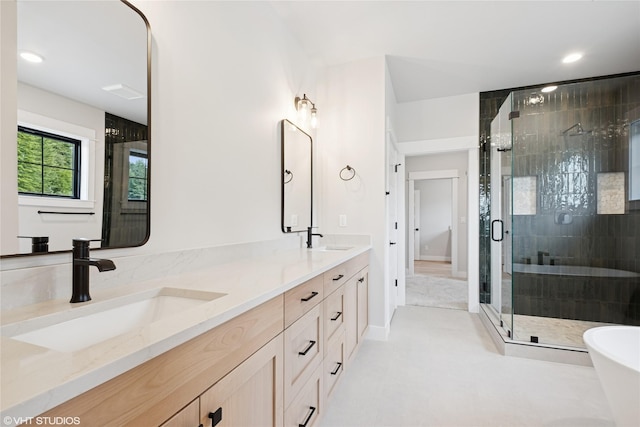 full bathroom featuring a shower stall, double vanity, recessed lighting, and a freestanding bath