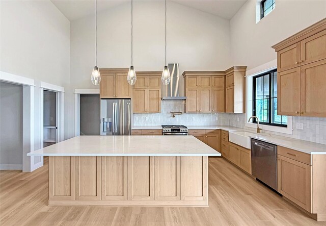 168 Wood Ridge Dr, Columbia Falls, MT 59912 - kitchen featuring appliances with stainless steel finishes, wall chimney exhaust hood, and light brown cabinets