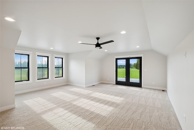 additional living space with light carpet, recessed lighting, a ceiling fan, vaulted ceiling, and baseboards