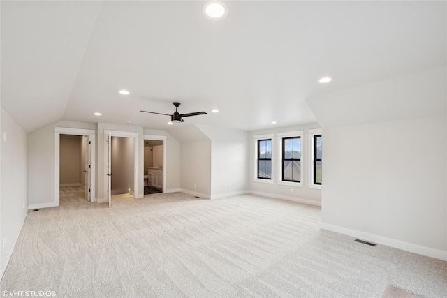 additional living space with light carpet, recessed lighting, vaulted ceiling, baseboards, and ceiling fan