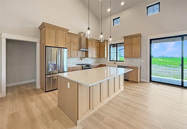 168 Wood Ridge Dr, Columbia Falls, MT 59912 - kitchen with wine cooler, high vaulted ceiling, light wood-style floors, light countertops, and a kitchen island