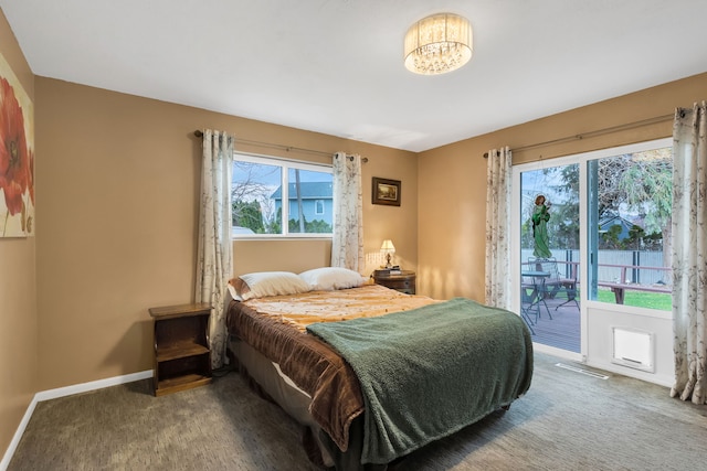 4003 Thomas Pl, Missoula, MT 59803 - carpeted bedroom featuring access to exterior, baseboards, and a chandelier