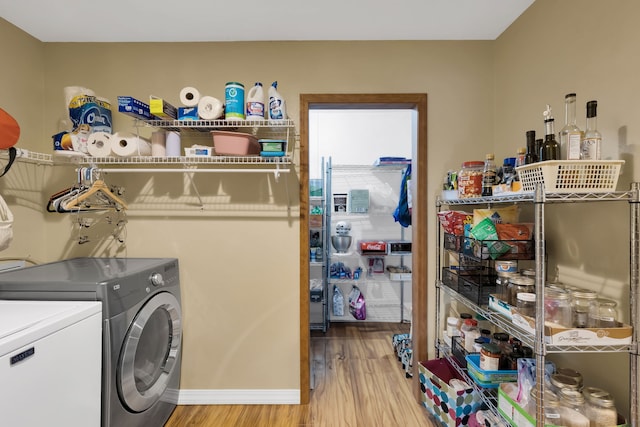 4003 Thomas Pl, Missoula, MT 59803 - laundry area featuring independent washer and dryer, light wood finished floors, and baseboards