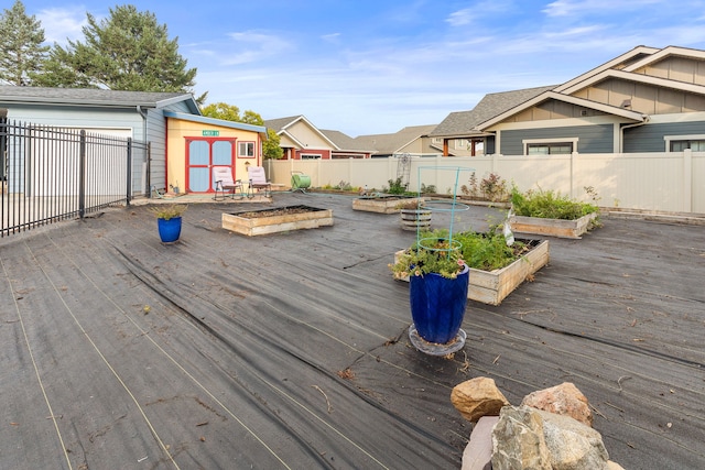 4003 Thomas Pl, Missoula, MT 59803 - wooden terrace with a vegetable garden, a storage shed, an outdoor structure, and a fenced backyard