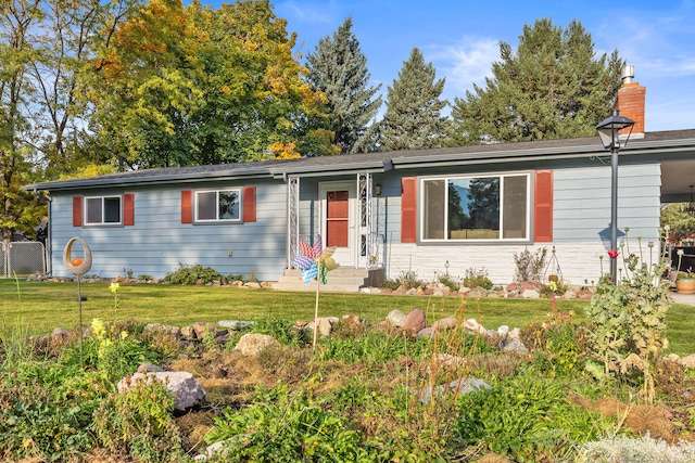 4003 Thomas Pl, Missoula, MT 59803 - ranch-style home with a front yard and a chimney
