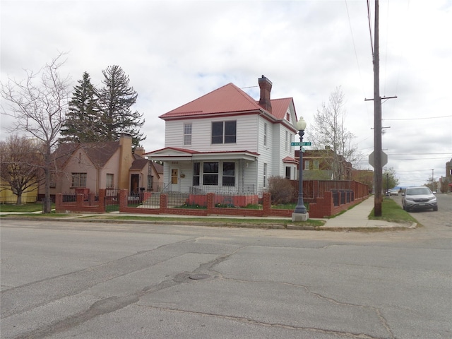 523 Hickory St, Anaconda, MT 59711 - view of front of home with covered porch, metal roof, and a chimney