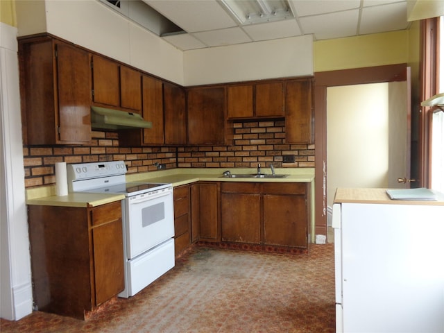 523 Hickory St, Anaconda, MT 59711 - kitchen with white range with electric cooktop, under cabinet range hood, a sink, light countertops, and a drop ceiling