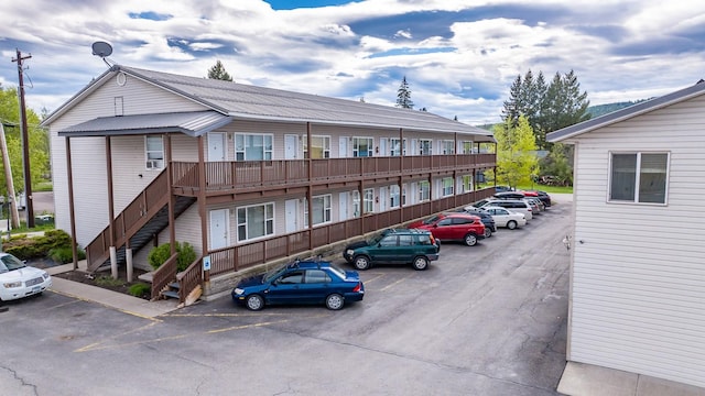 view of building exterior with uncovered parking