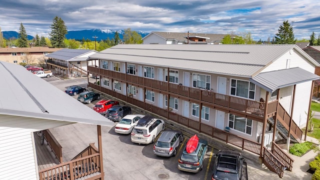 view of building exterior featuring uncovered parking and a mountain view
