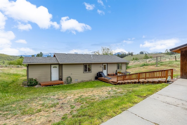 688 Black Horse Trl, Stevensville, MT 59870 - back of house with a deck with mountain view, a lawn, and a shingled roof