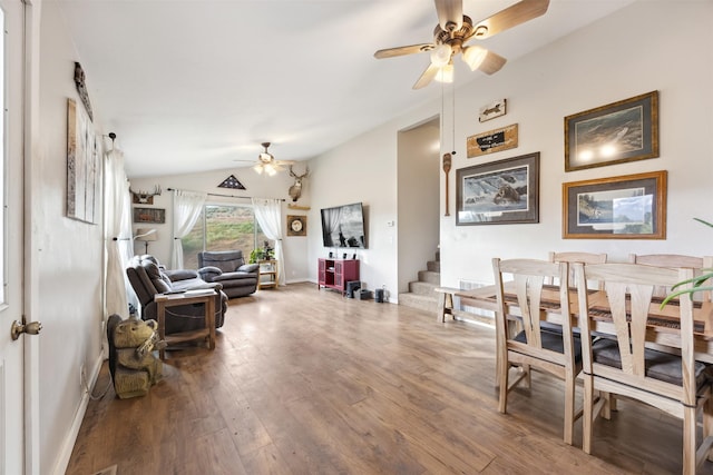 688 Black Horse Trl, Stevensville, MT 59870 - living area with a ceiling fan, lofted ceiling, wood finished floors, baseboards, and stairway