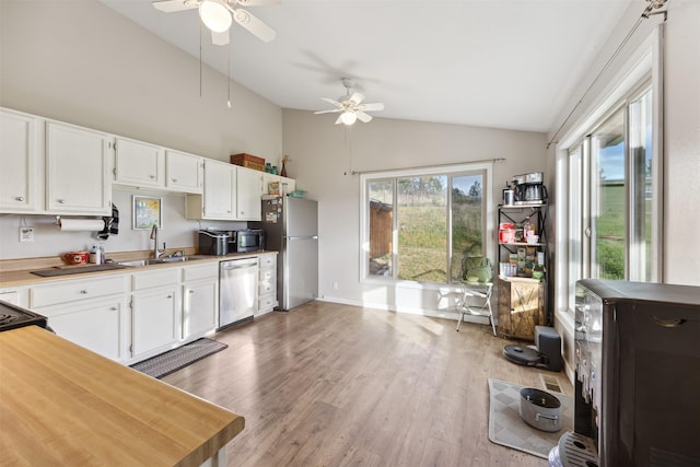 688 Black Horse Trl, Stevensville, MT 59870 - kitchen with appliances with stainless steel finishes, a sink, a ceiling fan, white cabinets, and light countertops