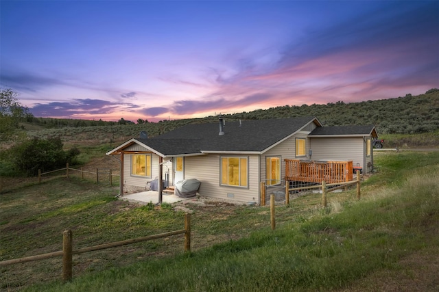 688 Black Horse Trl, Stevensville, MT 59870 - view of front facade with a patio, fence, and roof with shingles