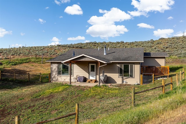 688 Black Horse Trl, Stevensville, MT 59870 - back of house with a patio area and a shingled roof