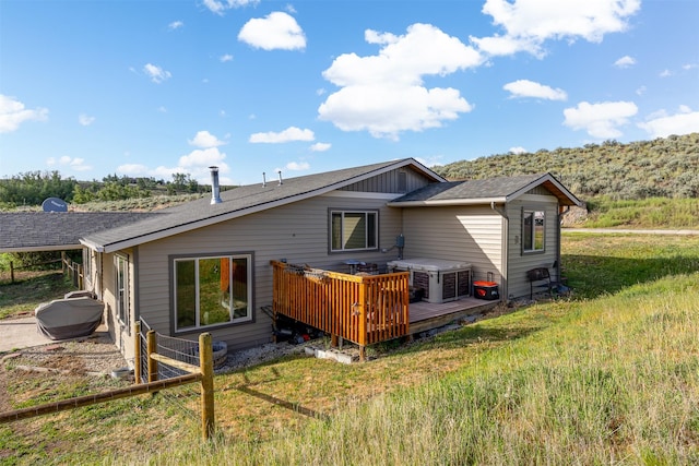 688 Black Horse Trl, Stevensville, MT 59870 - rear view of house featuring a wooden deck and a yard