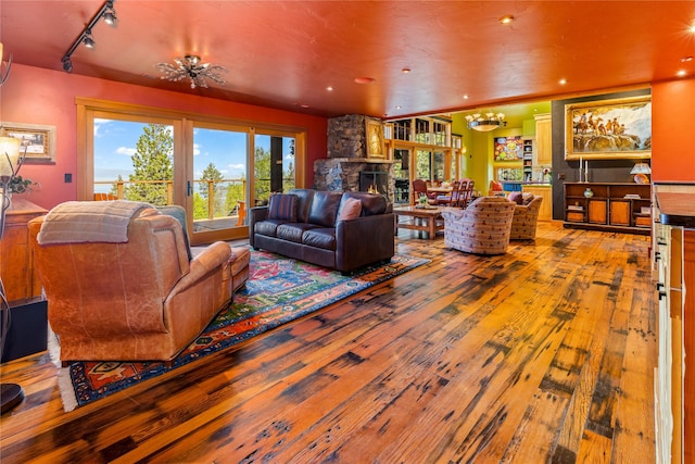 32220 Tamarack Dr, Bigfork, MT 59911 - living room featuring hardwood / wood-style floors, a chandelier, rail lighting, and recessed lighting