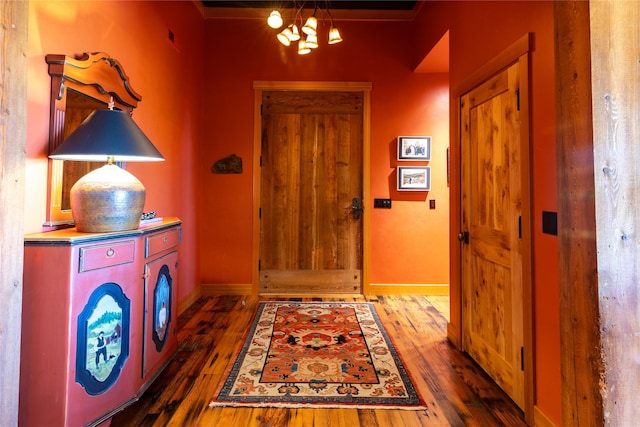 32220 Tamarack Dr, Bigfork, MT 59911 - entryway with wood finished floors, a chandelier, and crown molding