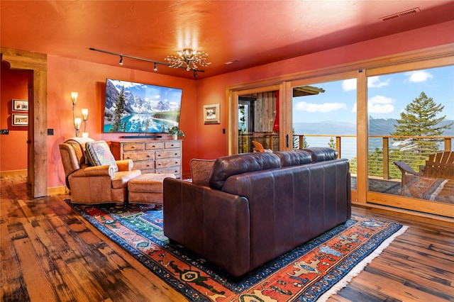 32220 Tamarack Dr, Bigfork, MT 59911 - living room featuring hardwood / wood-style floors, track lighting, and a chandelier