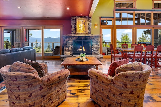 32220 Tamarack Dr, Bigfork, MT 59911 - living area with wood-type flooring, a fireplace, a mountain view, and recessed lighting