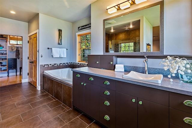 32220 Tamarack Dr, Bigfork, MT 59911 - bathroom with vanity, plenty of natural light, a garden tub, and tiled shower