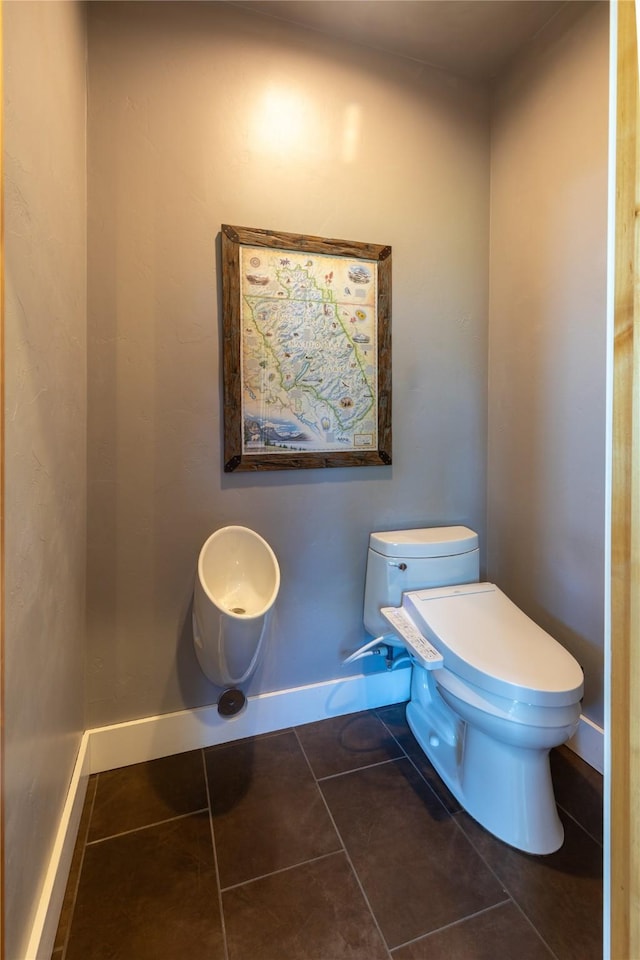 32220 Tamarack Dr, Bigfork, MT 59911 - half bathroom with toilet and tile patterned floors