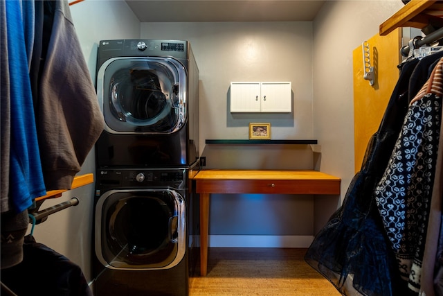 32220 Tamarack Dr, Bigfork, MT 59911 - washroom featuring stacked washer and clothes dryer and wood finished floors