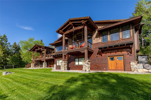 32220 Tamarack Dr, Bigfork, MT 59911 - rear view of property featuring a yard, a balcony, and stairway