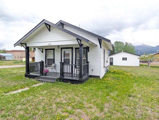403 Mission St, Stevensville, MT 59870 - shotgun-style home with covered porch and a front lawn