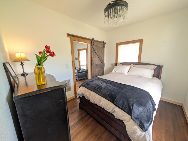 403 Mission St, Stevensville, MT 59870 - bedroom with baseboards, wood finished floors, a barn door, and a chandelier