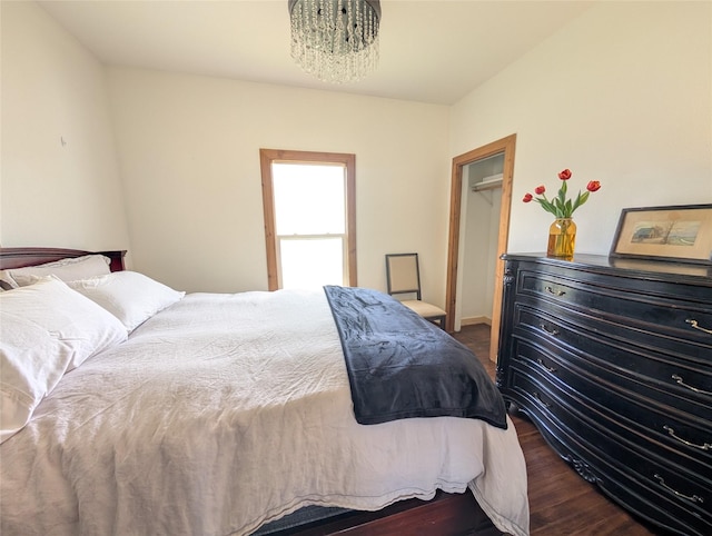 403 Mission St, Stevensville, MT 59870 - bedroom with a chandelier, wood finished floors, baseboards, and a spacious closet