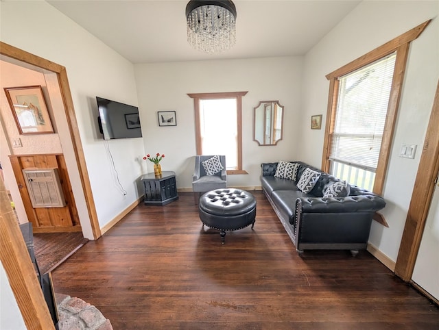 403 Mission St, Stevensville, MT 59870 - living area with healthy amount of natural light, wood finished floors, a chandelier, and baseboards