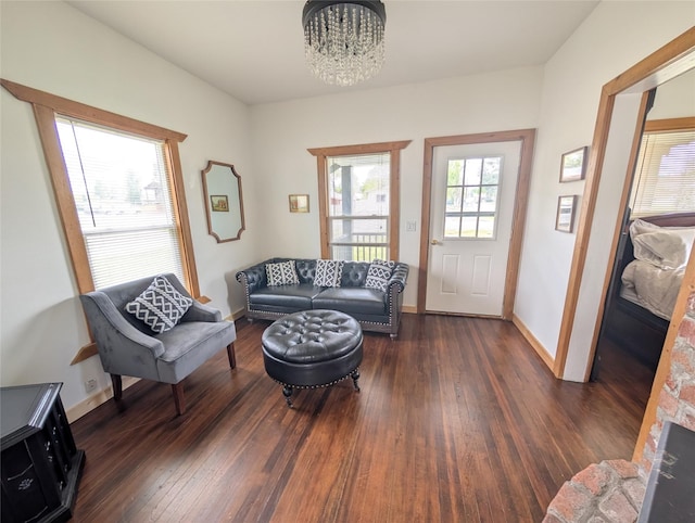 403 Mission St, Stevensville, MT 59870 - living area featuring a chandelier, dark wood-type flooring, and baseboards
