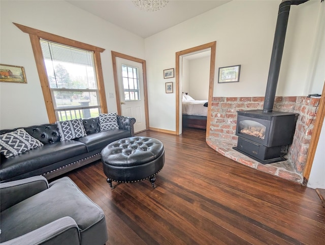 403 Mission St, Stevensville, MT 59870 - living room with wood finished floors, a wood stove, and baseboards