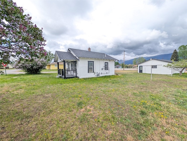 403 Mission St, Stevensville, MT 59870 - rear view of property with a lawn and a chimney
