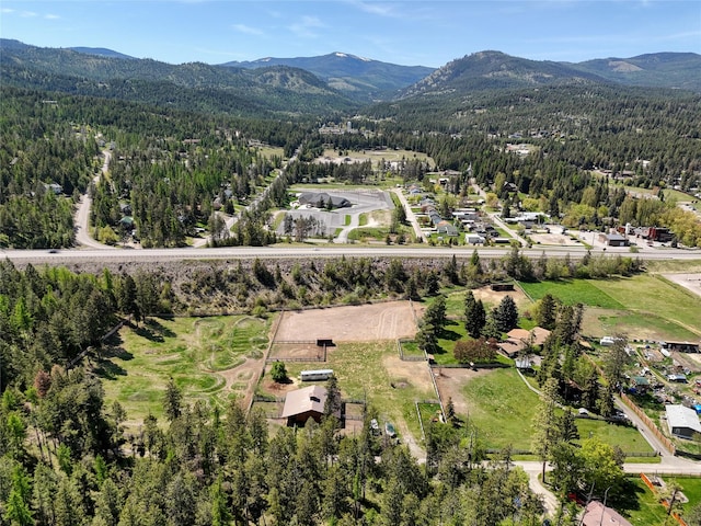 38 Lakeside Ave, Lakeside, MT 59922 - aerial overview of property's location featuring a mountain backdrop and a heavily wooded area