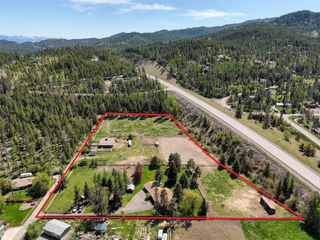 38 Lakeside Ave, Lakeside, MT 59922 - aerial view of property's location with a heavily wooded area, mountains, and property boundaries highlighted