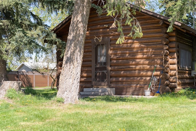 38 Lakeside Ave, Lakeside, MT 59922 - view of side of home featuring log exterior and a lawn
