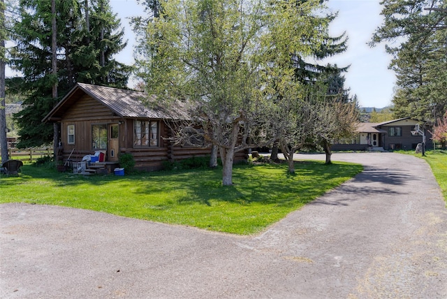38 Lakeside Ave, Lakeside, MT 59922 - view of front of property featuring driveway, a front lawn, and metal roof