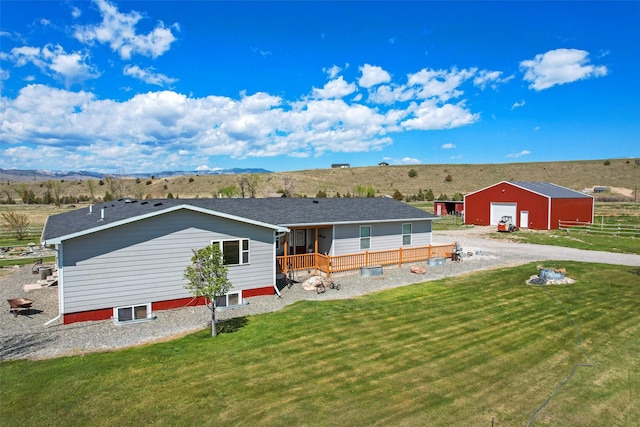 405 Lower Deep Creek Rd, Townsend, MT 59644 - rear view of house featuring an outbuilding, a garage, a yard, and a mountain view