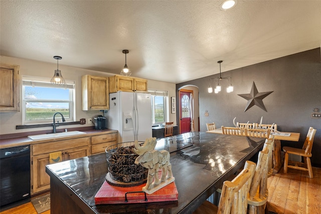 405 Lower Deep Creek Rd, Townsend, MT 59644 - kitchen with white refrigerator with ice dispenser, dishwasher, arched walkways, light wood-style flooring, and a textured ceiling