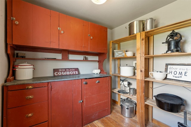 405 Lower Deep Creek Rd, Townsend, MT 59644 - kitchen featuring open shelves, light wood-style floors, and dark countertops