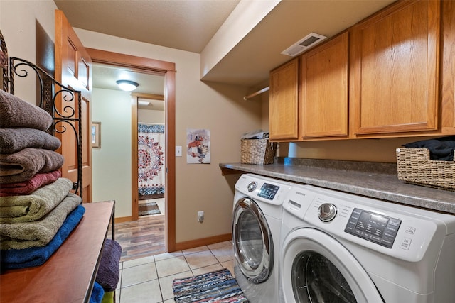 405 Lower Deep Creek Rd, Townsend, MT 59644 - laundry room with cabinet space, washer and clothes dryer, and light tile patterned floors