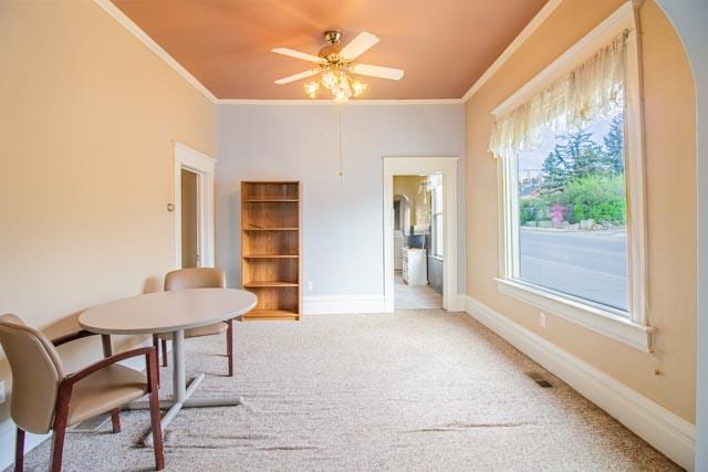 601 S Idaho St, Butte, MT 59701 - dining room featuring crown molding, ceiling fan, baseboards, carpet floors, and arched walkways