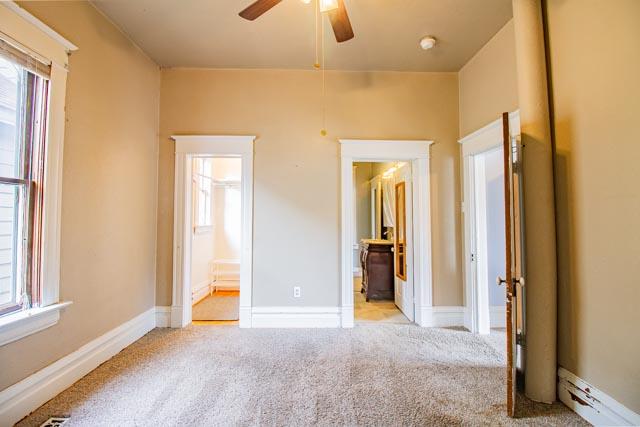 601 S Idaho St, Butte, MT 59701 - unfurnished bedroom with carpet flooring, ensuite bath, and a ceiling fan