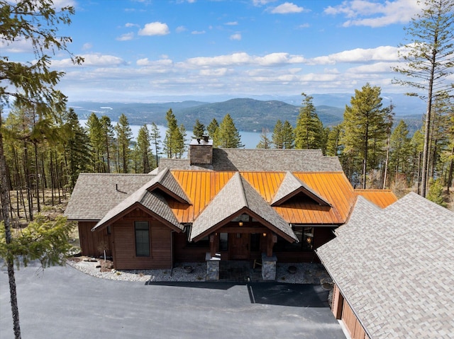 66 Elk Highlands Dr, Whitefish, MT 59937 - view of front of property featuring a standing seam roof, a mountain view, a chimney, and metal roof