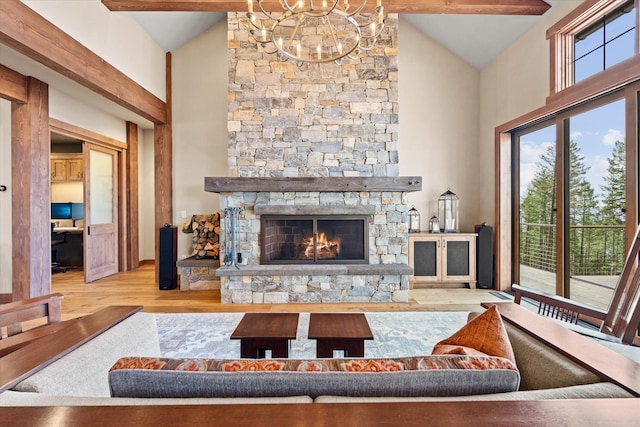 66 Elk Highlands Dr, Whitefish, MT 59937 - living area with high vaulted ceiling, wood finished floors, a chandelier, and a stone fireplace
