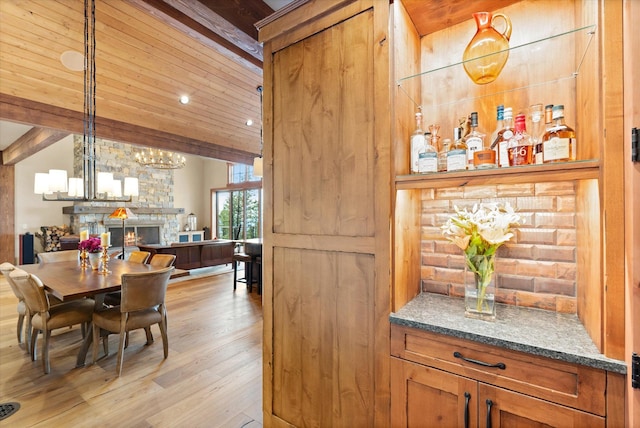 66 Elk Highlands Dr, Whitefish, MT 59937 - dining area featuring a chandelier, light wood-type flooring, beam ceiling, and wood ceiling