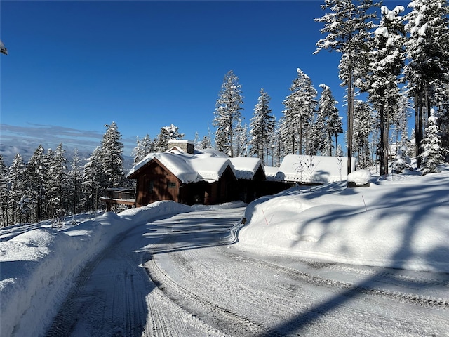 66 Elk Highlands Dr, Whitefish, MT 59937 - view of snowy exterior featuring a chimney