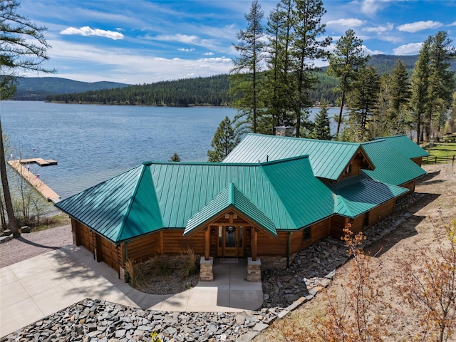 51605 Lake Mary Ronan Rd, Proctor, MT 59929 - exterior space featuring a water and mountain view, a wooded view, concrete driveway, and a garage